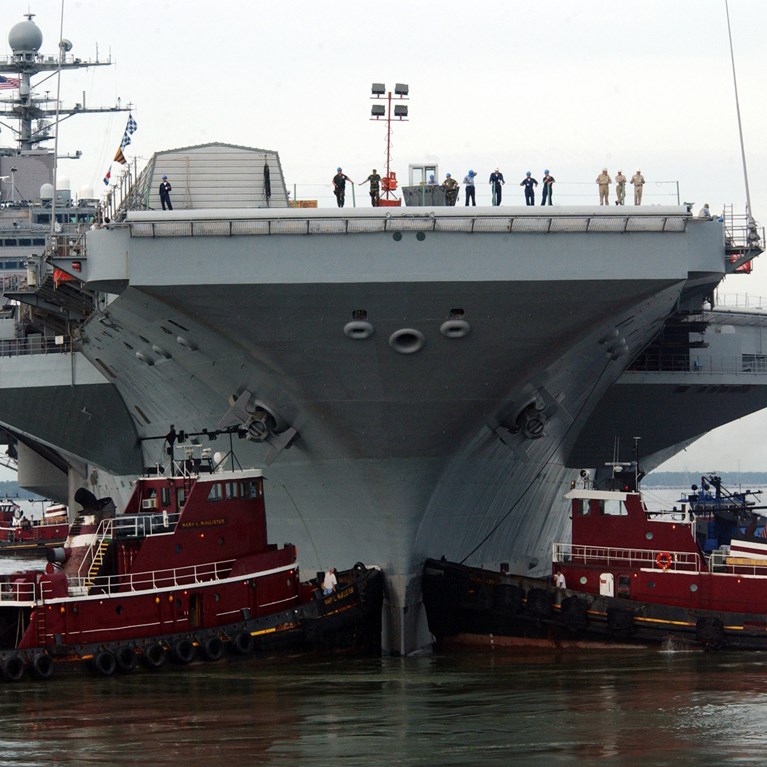 US Navy 050830 N 5188B 022 Two Tug Boats Steady The Bow Of The Nimitz Class Aircraft Carrier USS George Washington (CVN 73) As The Nuclear Powered Ship Transits From The Dry Dock